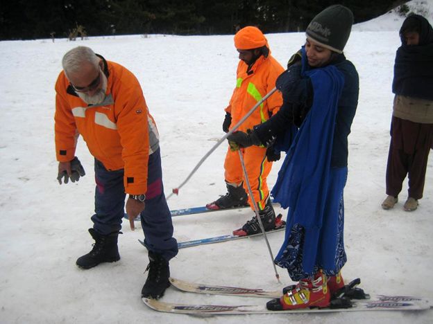 Matee Ullah Khan speaking to someone on skis