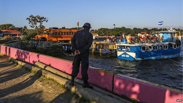 A navy soldier watches the boats depart from Lake Nicaragua on 11 December, 2014