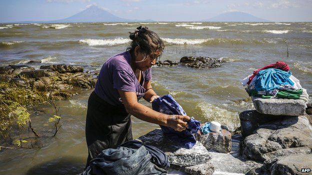 A woman washes clothes on the shore of Cocibolca lake in Rivas, Nicaragua on 11 December, 2014