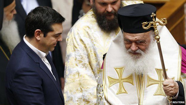 Greek Prime Minister Alexis Tsipras greets the leader of Greek church Ieronimos (R) and other orthodox priests before a swearing in ceremony for Greece's new lawmakers in the Greek parliament in Athens February 5, 2015