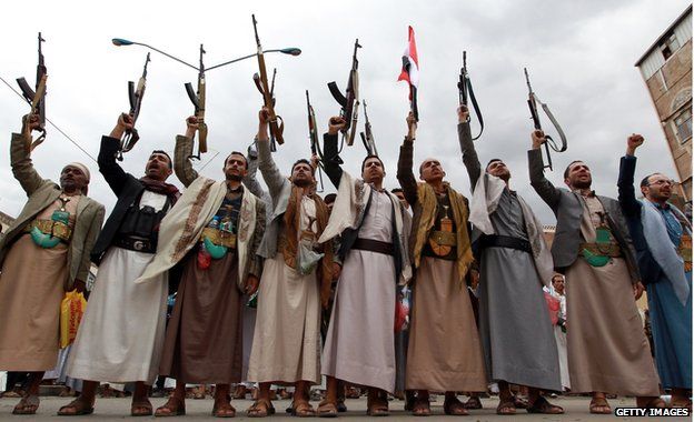 Tribal gunmen loyal to the Houthi movement brandish their weapons on 26 March, 2015