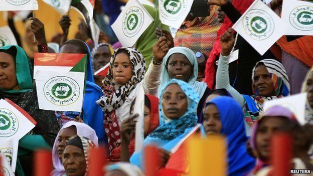 Supporters wave National Congress party (NCP) flags during a campaign launch for Sudanese President and NCP candidate Omar al-Bashir ahead of the 2015 elections at Marikh Stadium in Omdurman