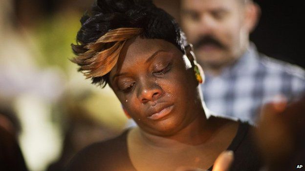 Tears roll down the face of Candice Ancrum, of Summerville, S.C., as she attends a candlelight vigil outside city hall protesting the shooting death of Walter Scott 8 April 2015