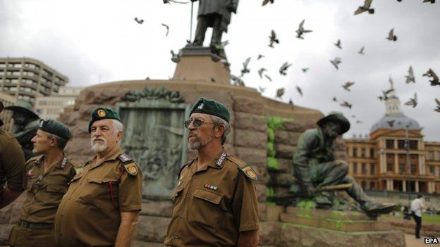 Afrikaner members of the Boere Kommando stand at the base of the memorial for Afrikaner hero Paul Kruger in central Pretoria, South Africa, 8 April 2015