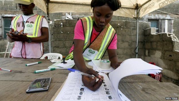 An electoral officer checks through a list during governorship election in Ajah district of Lagos April 11, 2015.