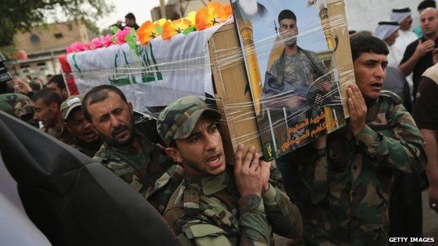 Members of the Badr Brigade Shia militia carry the coffin of a comrade in Baghdad, Iraq (11 April 2015)