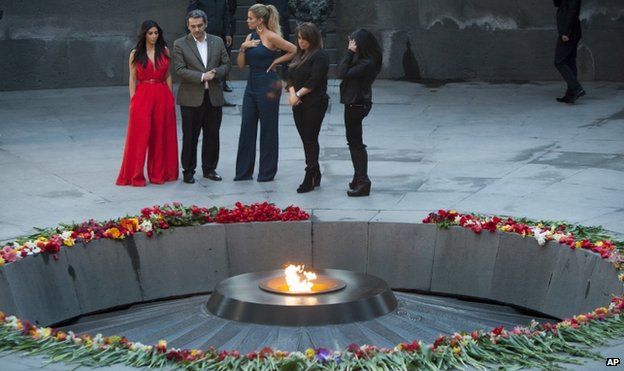 Kim Kardashian (L) with sister Khloe (C) at genocide memorial