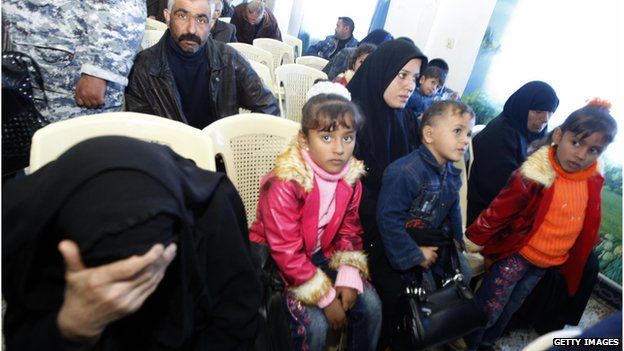 An Iraqi woman whose husband was killed sits with her children listening during a meeting with US Federal Prosecutors to discuss the case against the security firm Blackwater