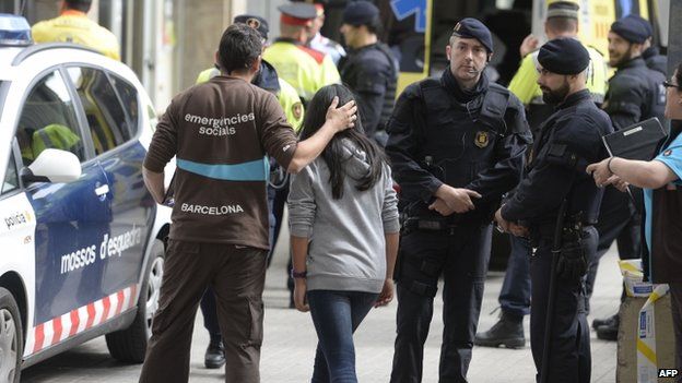 Emergency service members attend students at the Joan Fuste Institue in Barcelona on April 20, 2015