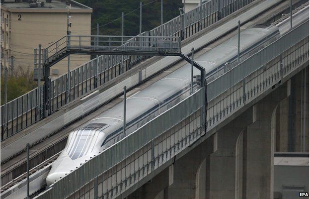 A handout picture provided by the Central Japan Railway Co shows a maglev train speeding on an experimental track in Yamanashi Prefecture, central Japan, 21 April 2015