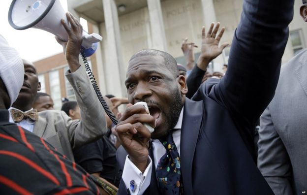 Pastor Jamal Bryant yells into a loud speaker