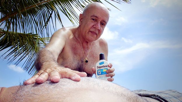 Applying sun cream on a beach in Florida, USA
