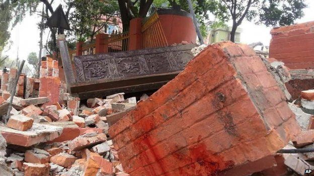 In this photo released by China's Xinhua News Agency, a collapsed building is seen in Nepal's capital Kathmandu Saturday, April 25, 2015