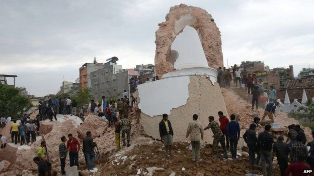 Nepalese rescue members and onlookers gather at the collapsed Dharahara Tower in Kathmandu on April 25, 2015