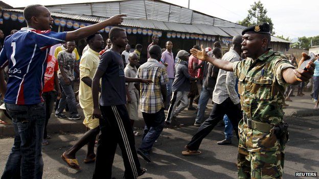 A military officer tries to control protesters in Bujumbura, April 27, 2015
