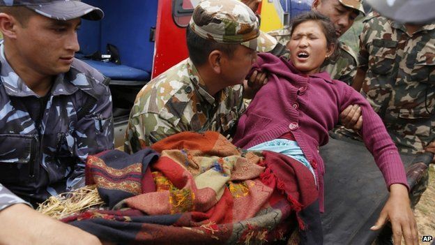 Injured woman arrives by helicopter from Ranachour village at town of Gorkha, Nepal. 28 April 2015