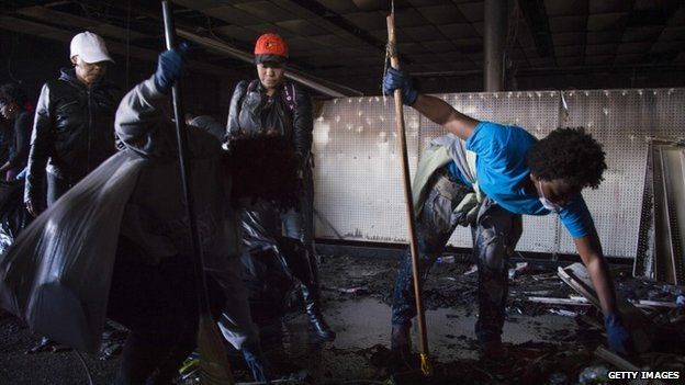Local people clean out the CVS Pharmacy in Baltimore, Maryland, April 28, 2015,
