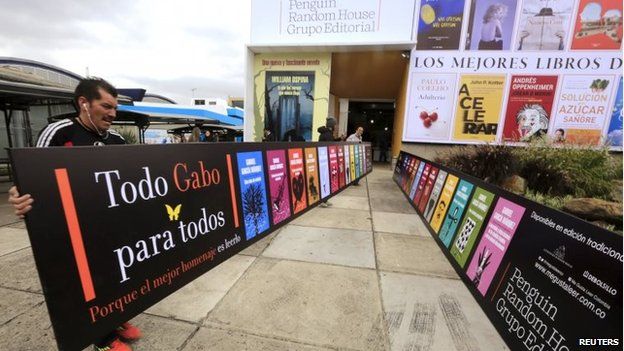 Workers carry a banner at the entrance of a library during Bogota's 28th International Book Fair, or Filbo 2015, on 22 April, 2015.
