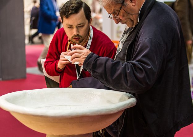 Two men looking at a font