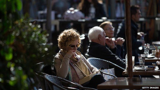 People sit at outside tables in a cafe in Athens following the electoral success by Syriza in the Greek general election (January 2015)