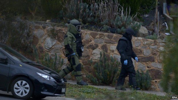 Officers wearing bomb suits raid a house in Greenvale, Melbourne, Australia, 8 May 2015