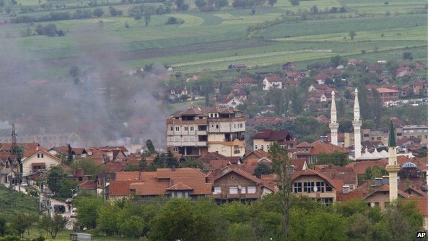 Smoke billows from a house in an area being investigated by the police, in northern Macedonian town of Kumanovo, 9 May 2015