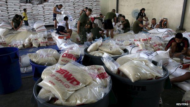 Members of the Armed Forces of the Philippines help out volunteers repacking food rations for victims of Typhoon Noul at the Department of Social Welfare Development (DSWD) headquarters in Pasay city, south of Manila May 9, 2015