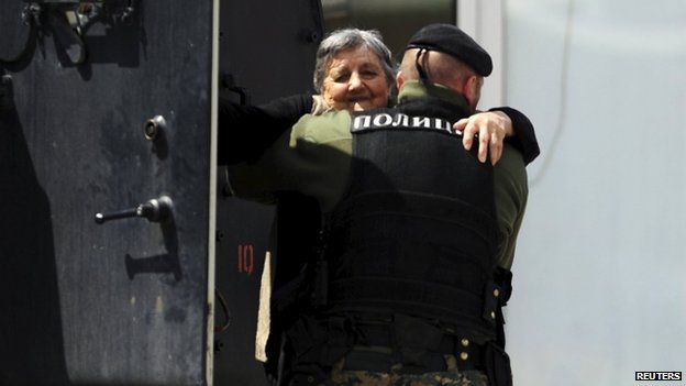 An elderly woman is evacuated in an armoured vehicle near a police checkpoint in Kumanovo, Macedonia May 10, 2015