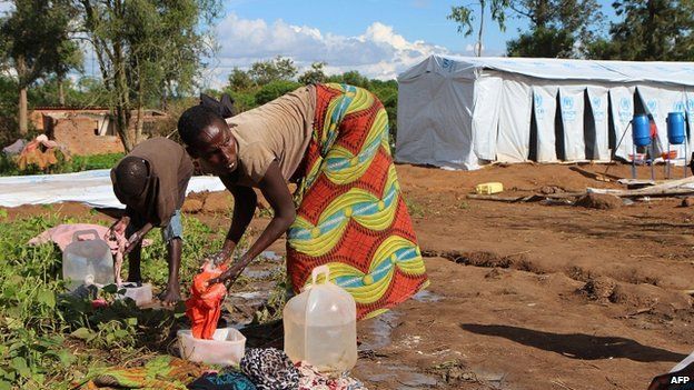 Burundian refugees wash clothes on 9 May 2015 at a temporary shelter at the Gashora refugee camp in the Bugesera district of Rwanda
