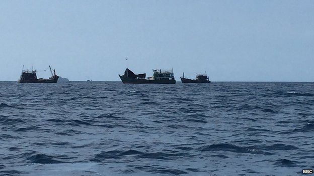 The boat surrounded by Thai fishing boats