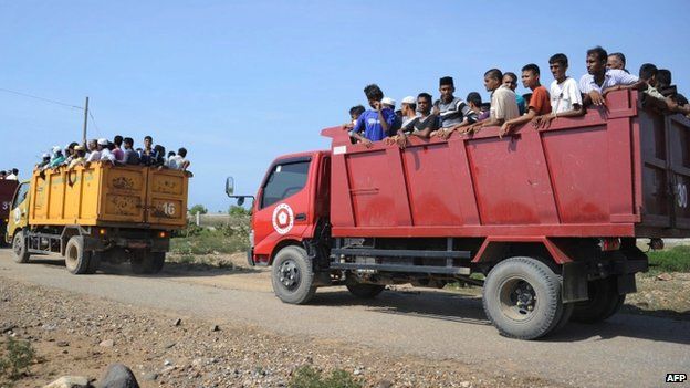 Rescued migrants, mostly Rohingyas from Myanmar and Bangladesh, are transported by trucks to the fishing town of Kuala Cangkoi in Aceh province, Indonesia (13 May 2015)