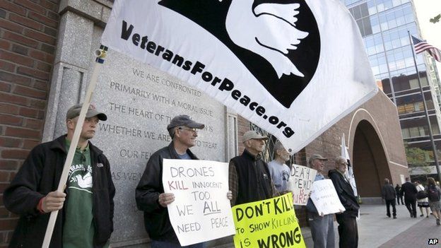 Winston Warfield, of Boston, second from left, holds a placard while standing with other protesters outside federal court as they demonstrate against the death penalty 14 May 2015