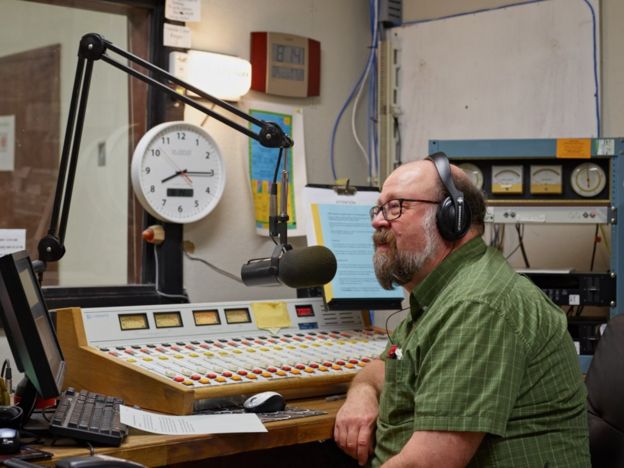 Chuck Niday in a radio studio