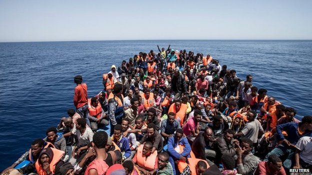 Migrants crowd the deck of their wooden boat off the coast of Libya, 14 May 2015