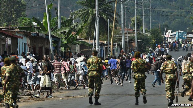 Protestors run as soldiers fire shots in the air during a demonstration in Bujumbura on May 18, 2015