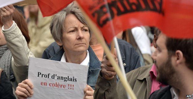 A woman holds a placard reading "English teachers angry" during a demonstration against proposed reforms of secondary education during a teacher's national strike day on 19 May 2015 in Strasbourg, France