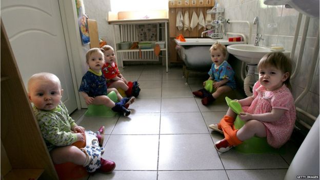 Children sitting on potties in an orphanage for HIV positive kids in Moscow
