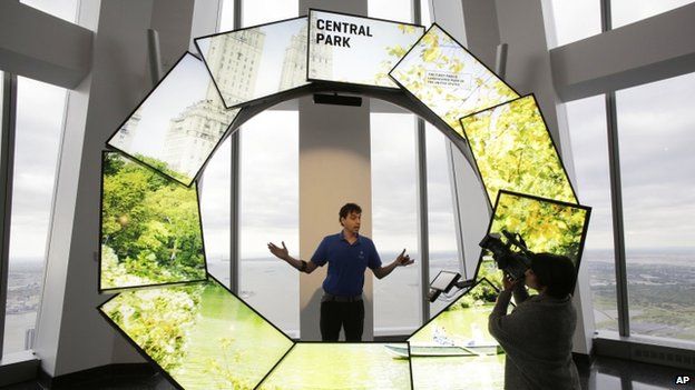 Eric Robinson, center, demonstrates City Pulse at One World Observatory, Wednesday, May 20, 2015, in New York