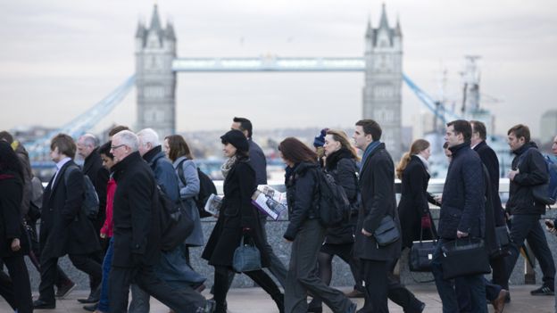 Commuters walking over London Bridge