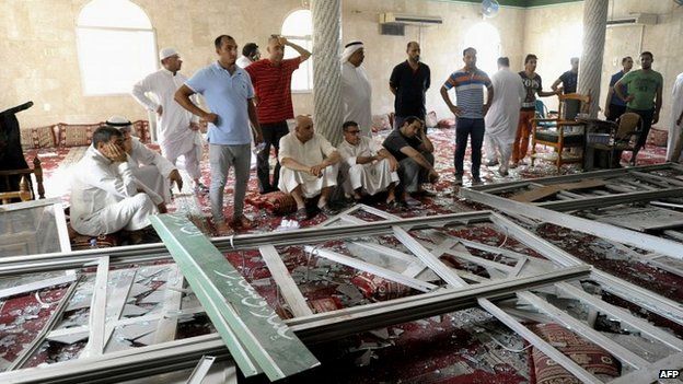 Saudi men gather around debris following the blast inside the mosque in the coastal town of Qatif - 22 May 2015