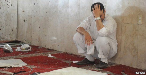 A family member of a slain victim mourns after arriving at the mosque attacked by IS in eastern Saudi Arabia - 22 May 2015