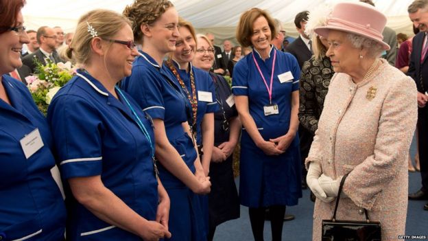 Queen Elizabeth II (R) meets midwives at the Rosie Maternity Hospital on May 23, 2013 in Cambridge, England.