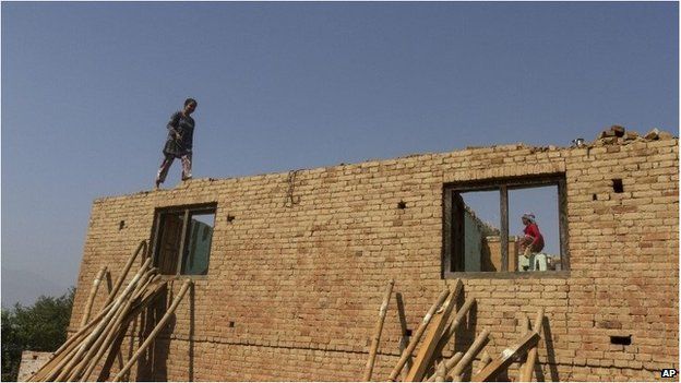 Local people in the ruins of a collapsed house after the massive earthquake in Changunarayan on the outskirts of Bhaktapur on 22 May.