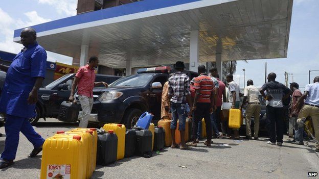 People queue with jerry cans to buy fuel at Mobil filling station in Lagos, on May 21