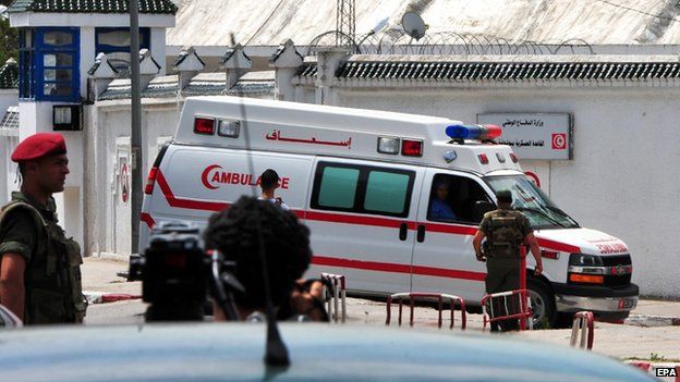 An ambulance is seen outside the Bouchoucha army barracks after a shootout incident, in Tunis 25 May