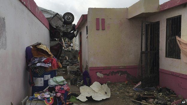 Car on roof of a house in Ciudad Acuna. 25 May 2015
