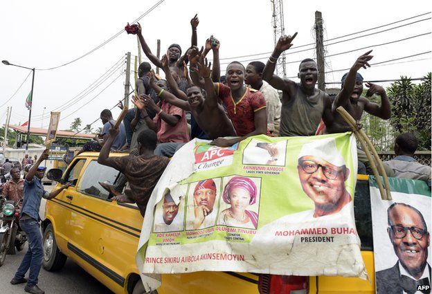 Supporters of newly-elected Nigerian President Muhammadu Buhari sit on top of a bus as they celebrate the victory their candidate in Lagos on April 1
