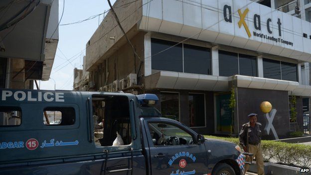 Pakistani policemen stand guard outside the offices of software house Axact in Karachi (27 May 2015)