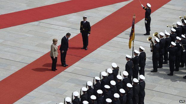 Angela Merkel and David Cameron inspect a military honour guard prior to a meeting