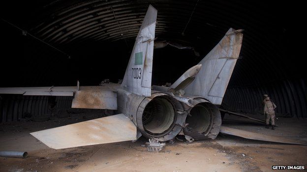 National Transitional Council (NTC) fighters search the sirte airport, which had been bombed by Nato Fighters, on October 7, 2011 in Sirte, Libya